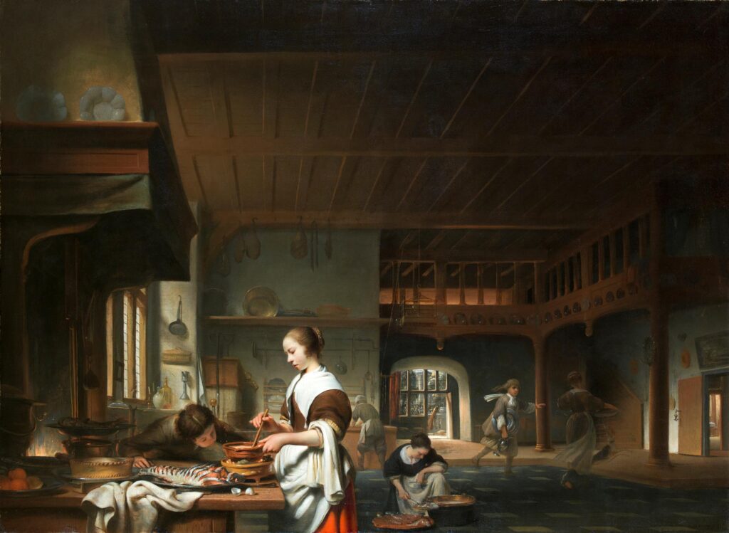 In een grote open ruimte staat een jonge vrouw aan een tafel die naast de schouw staat te roeren in een schaal. Voor haar op tafel licht een ingekerfde zalm en staat een pastei. Links naast haar licht een eierschil, ze heeft een doek over haar arm. Naast haar blaast een jongen het vuur onder de pan aan. In de schouw zien we net het vuur en het spit dat er voor sttat. In het midden van de ruimte zit een vrouw geknield te werken en achter bij een tafel staat ook nog iemand. Rechts lopen een meid en een jongen met tinnen servies naar de deur die verder het huis in leidt.