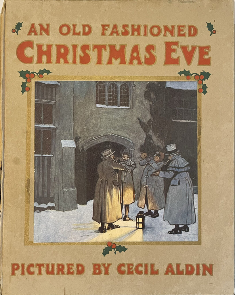 Kaft van het boek An old fashioned Christmas Eve uit 1910. Een bruinige kaft met de titel in rode letters. Een vrij donker afbeelding van mensen die op straat kerstliedjes zingen rondom een lamp. Onder de afbeelding in rode letters de tekst Pictures by Cecil Aldin.