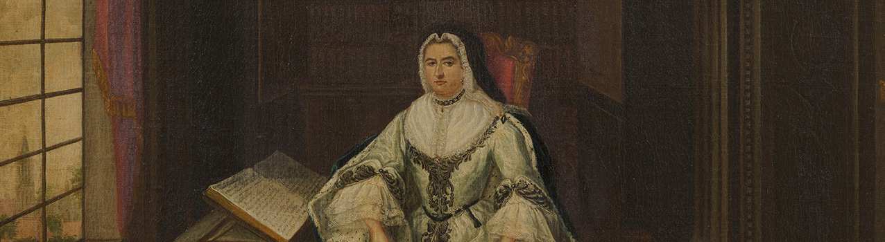 Een dame (Henriëtte van Nassau Zuylestein) zit achter een tafel met een heel groot boek naast zich.