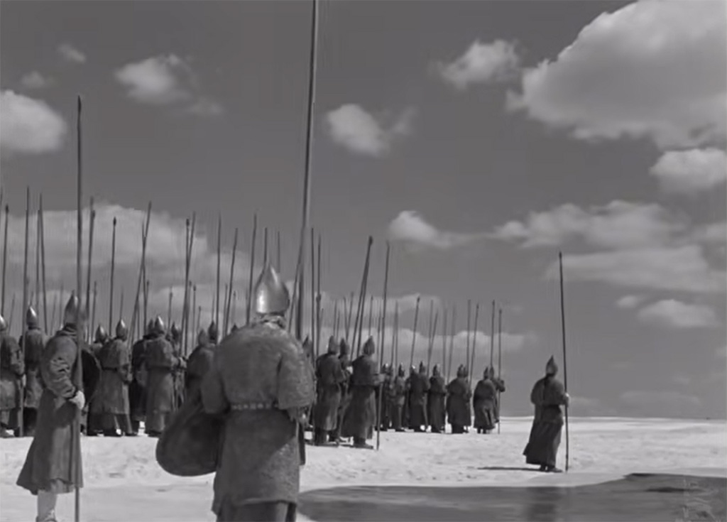 Op een grote ijsvlakte staan soldaten met speren in de hand.