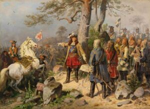 Schilderij van Keurvorst Frederik Willem in het midden voor een boom. Hij draagt een hoed met veren, een kuras met blauwe sjerp, daarover heen een lichtbruine jas, witte handschoenen een rode broek en hoge donkere laarzen. Recht van hem staan goedgeklede heren aandachtig naar hem te luisteren. Links van hem een steigerend wit paard en daarachter meer troepen te paard.
