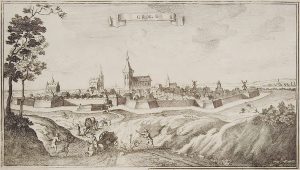 Gravure van een vestingstad omgeven door een gracht. Boven de muren van de stad steken vier kerken uit en op de muren staan diverse molens. Op de voorgrond, op de web naar de stad toe, valt een paard en wagen om, een vrouw valt van de wagen en drie mannen rennen geschrokken naar het ongeval. Op een banier bovenaan staat Grol.